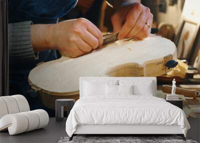 Close up of professional master artisan luthier painstaking detailed work on wood violin in a workshop. Wall mural