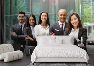 portrait of business people of different ethnic backgrounds dressed in suits, they smile and cross t Wall mural