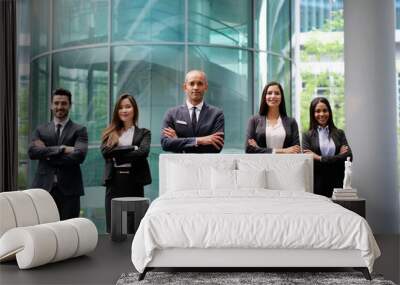 Portrait of business people of different ethnic backgrounds dressed in suits, they smile and cross their arms. Concept of: internationality and career, cooperation and team. Wall mural