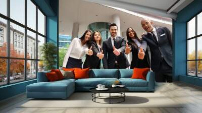 Portrait of business people of different ethnic backgrounds dressed in suits, they smile and cross their arms. Concept of: internationality and career, cooperation and team. Wall mural