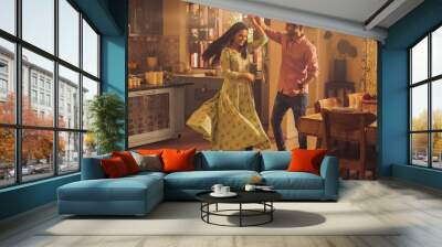 Young Couple Dancing and Having Fun in the Kitchen. Boyfriend and Girlfriend Sharing Moment of Love and Tenderness. With Joyful Laughter and Smiles, they Embrace the Music and Dance.  Wall mural