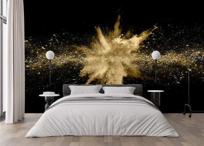 Golden powder explosion on black background. Freeze motion. Wall mural