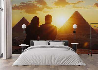 A couple gazing in wonder at pyramids of Giza during sunset Wall mural