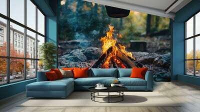 A cozy campfire surrounded by stones, with smoke rising and a pot suspended above, perfect for outdoor cooking. Wall mural