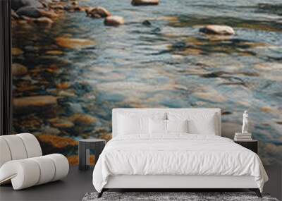 A crystal clear mountain stream flows over smooth river rocks. The water is so clear that you can see the bottom. The scene is peaceful and serene, perfect for a relaxing escape. Wall mural