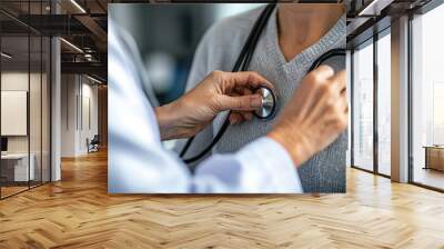 A doctor wearing stethoscope checks patients heart health with care Wall mural