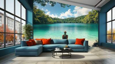 A person staring in wonder at crystal clear turquoise water Wall mural