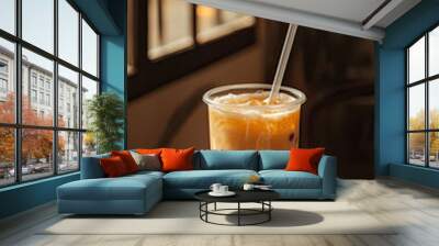 A refreshing milk tea with tapioca pearls sits on marble table, illuminated by soft sunlight streaming through window. drink, served in clear cup with straw, invites moment of relaxation Wall mural