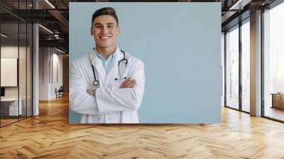 a smiling doctor with a stethoscope around his neck. Wall mural