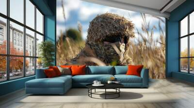 A soldier wearing a camouflage uniform and a natural disguise, seamlessly blending into the vibrant field of tall grass. Wall mural