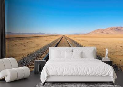 A striking image of a railway track stretching into the desert under a clear blue sky, symbolizing adventure and exploration. Wall mural