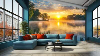 A tranquil lake bathed in the golden hues of sunrise, with wisps of mist adding an ethereal touch to the scene. Wall mural