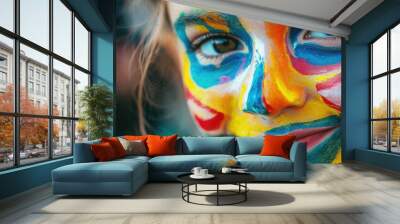 A young child with vibrant face paint, showcasing intricate patterns in bright colors, embodying joy and creativity. Wall mural