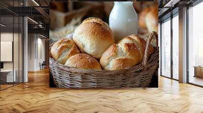 Freshly baked rolls in a wicker basket with a bottle of milk, perfect for breakfast or a cozy meal setting. Wall mural