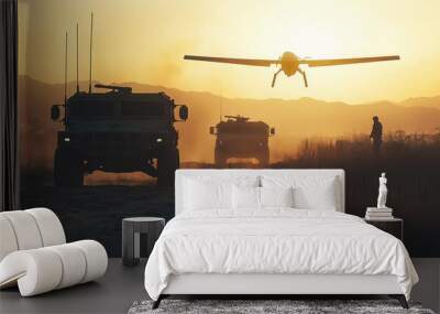 Military vehicles on rugged terrain at sunset, with a drone flying overhead, showcasing modern technology and tactical operations. Wall mural