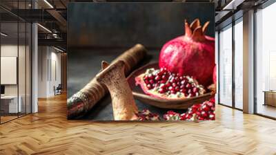 Pomegranates and shofar create beautiful scene for Rosh Hashanah, symbolizing abundance and renewal. vibrant red seeds and intricate textures evoke sense of celebration and tradition Wall mural