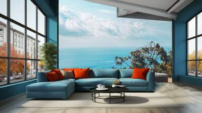 Serene infinity pool overlooking the ocean, featuring modern architecture and clear blue skies, perfect for relaxation and escape. Wall mural