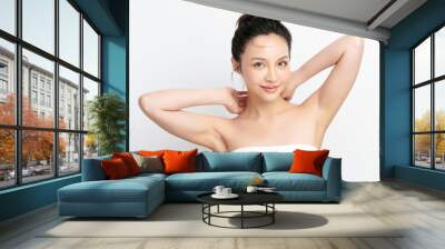 Beautiful Young Asian woman lifting hands up to show off clean and hygienic armpits or underarms on white background, Smooth armpit cleanliness and protection concept Wall mural