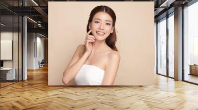 Beautiful young asian woman with clean fresh skin on beige background, Face care, Facial treatment, Cosmetology, beauty and spa, Asian women portrait. Wall mural