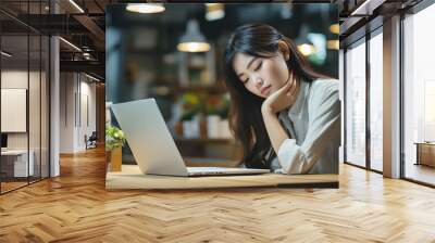 asian businesswoman working in the office with eye strain from the computer Wall mural