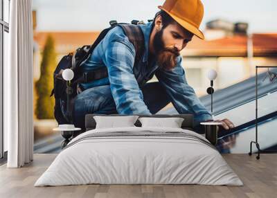 Man worker installing solar photovoltaic panels on roof, alternative energy, saving resources and sustainable lifestyle concept Generative AI Wall mural