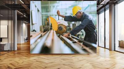 African man worker working cutting steel pipes For use in specific tasks with intention in the steel factory Wall mural