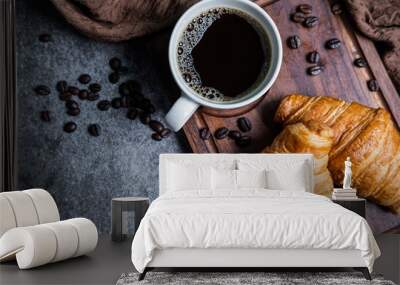 Breakfast with fresh croissants and cup of black coffee on wooden board Wall mural