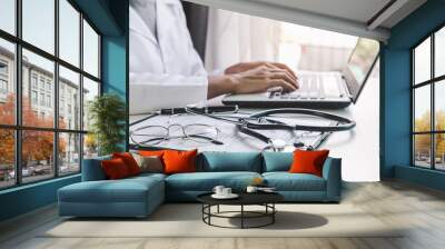 Doctor using a laptop in the hospital, Healthcare and Medicine concept Wall mural