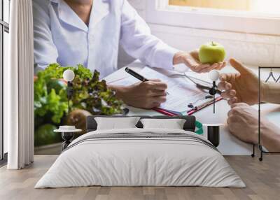 Nutritionist giving consultation to patient with healthy fruit and vegetable, Right nutrition and diet concept Wall mural