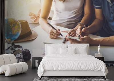 Young couple planning vacation trip Wall mural