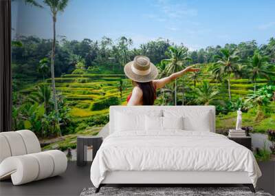 Young couple traveler looking at the beautiful tegalalang rice terrace in Bali, Indonesia Wall mural