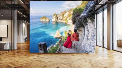 Young couple traveler relaxing and enjoying the beautiful view at diamond beach in Nusa Penida island, Bali Wall mural