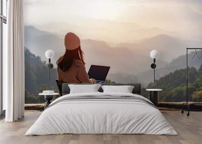 young woman freelancer traveler working online using laptop and enjoying the beautiful nature landsc Wall mural