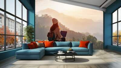 young woman freelancer traveler working online using laptop and enjoying the beautiful nature landsc Wall mural