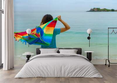 Young woman relaxing and enjoying at the tropical beach, Summer vacation and travel concept Wall mural