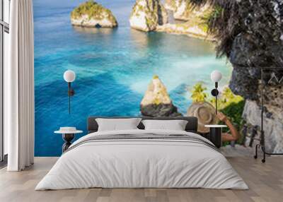 Young woman traveler relaxing and enjoying the beautiful view at diamond beach in Nusa Penida island, Bali Wall mural