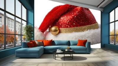 A bright red and white festive Santa Claus hat with a fluffy white pom-pom and sparkly golden buckle sits alone on a transparent background. Wall mural