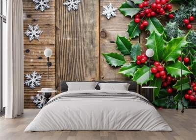 Vibrant red and green festive holly leaves, berries, and snowflakes adorn a rustic wooden background, perfect for a cozy and inviting holiday season greeting. Wall mural