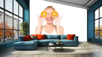 Closed up portrait of asian woman closes her eyes to halves of an orange, smiling beautiful and emotionally.Nice laughing girl with orange slices in front of her eye ,isolated on white with copy space Wall mural