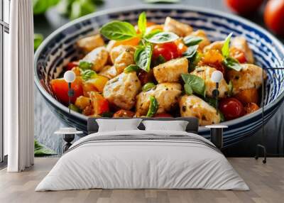 Closeup of a Vibrant Chicken and Tomato Salad with Basil in a Blue and White Striped Bowl on a Dark Wooden Table Wall mural