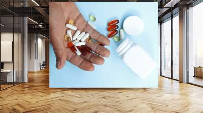 Asian elderly holding pill drug in hand Wall mural