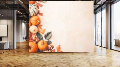 Autumn background with pumpkins and leaves on a beige surface, with copy space Wall mural