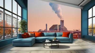 dramatic view factory with steam coming out of chimney, rising into sunset sky, captures power and industry, environmental impact of industrialization, sustainable practices of modern world Wall mural