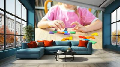 little 5 year old girl playing at home with wooden blocks, child's hand explore intricate world colorful wooden puzzle, nurturing creativity, imagination and problem-solving skills Wall mural