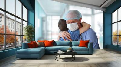 little patient is hugged by a male doctor, therapist, pediatrician, concept of medical treatment, insurance, professional care and trust, gratitude Wall mural