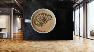 white cup with cappuccino and foam in the form of a silhouette of the brain on a black background, top view, close-up, copy space Wall mural