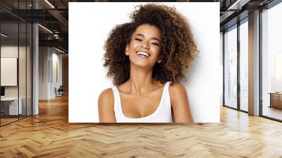 Beautiful african american girl with an afro hairstyle smiling Wall mural