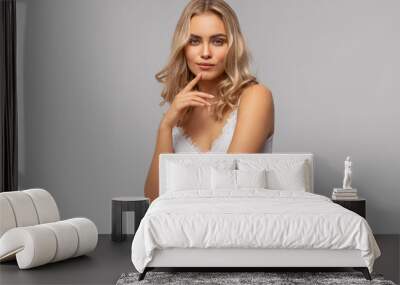 Beautiful blonde female model isolated on gray background Wall mural