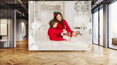 Beautiful smiling girl with her younger brother celebrating a Ch Wall mural