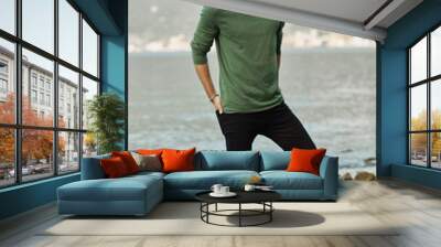 Fashionable male model standing near the lake Wall mural